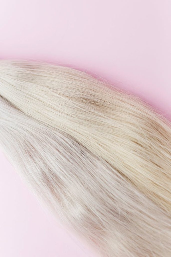 Mastering the First Impression: Your intriguing post title goes here Close-up of blond hair on a pastel backdrop, showing texture and color.